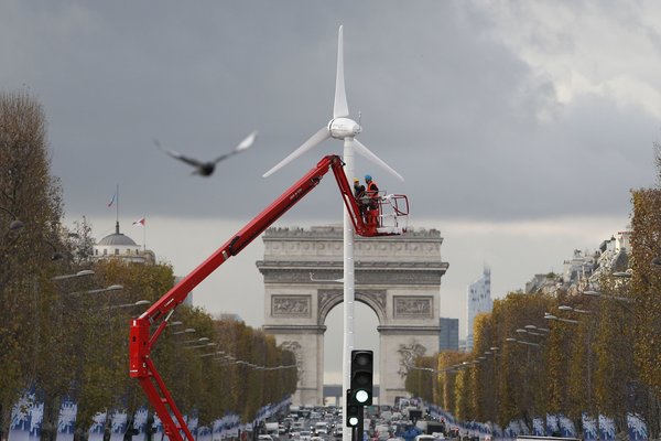 Windmill on the Champs-Élysées in Paris,  Credit Patrick Kovarik/Agence France-Presse — Getty Images 