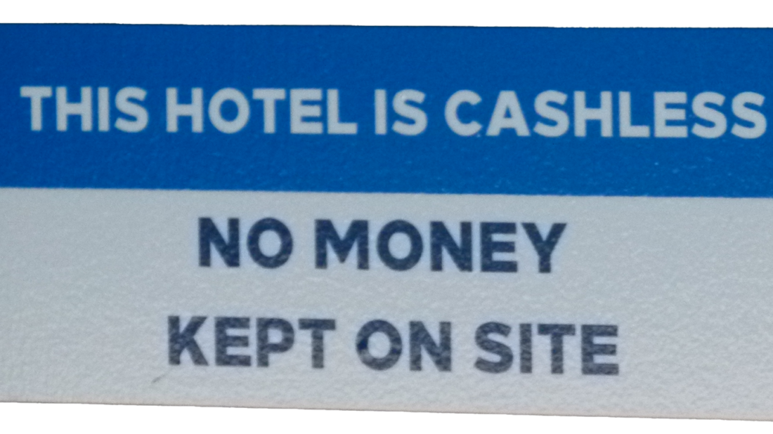 Photo of blue and white sign that says "This hotel is cashless, no money on site"