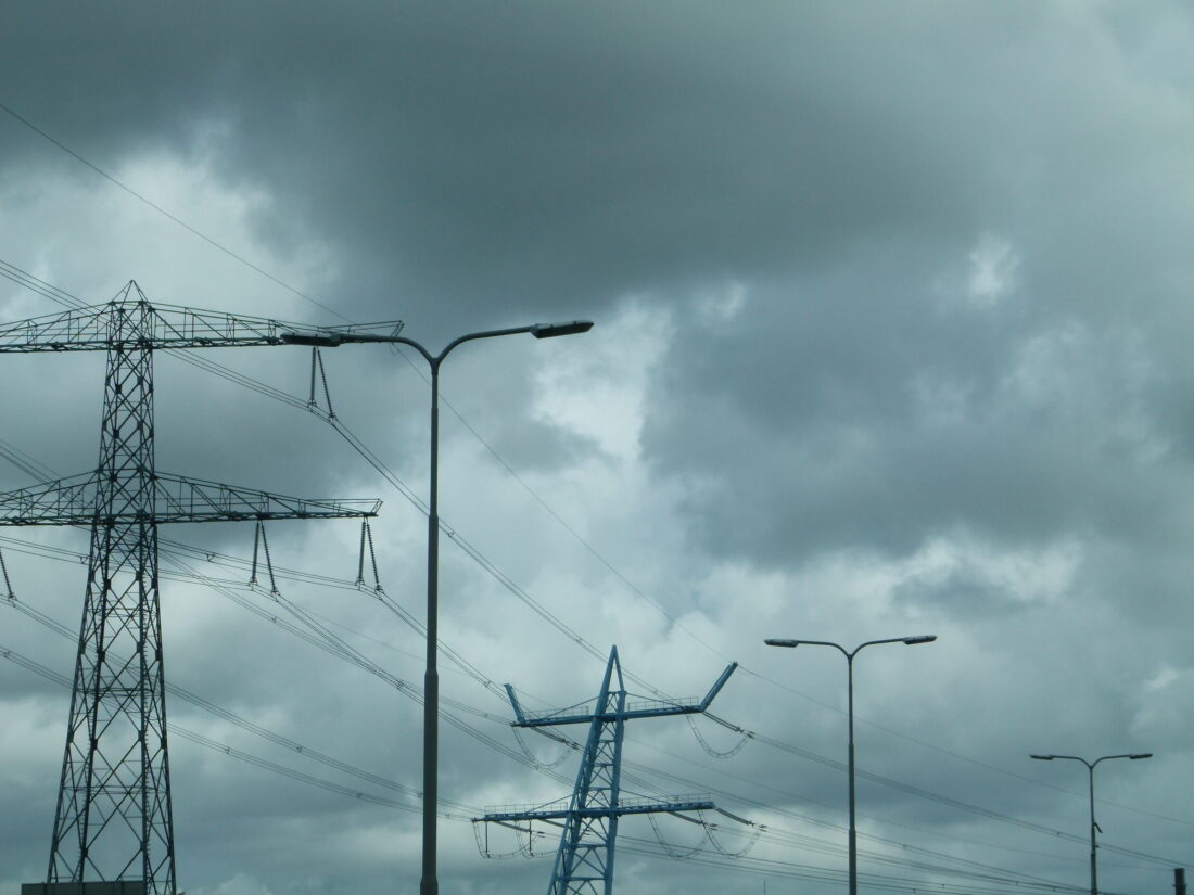 High voltage power lines against a cloudy sky